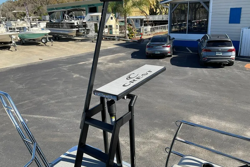 Slide: The Image of 2026 Crest Conquest 230 SLSC boat ladder in a marina parking lot. - 35