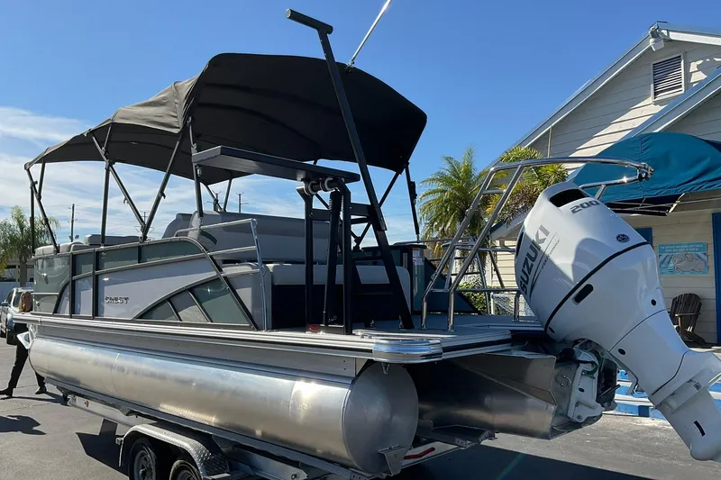 Slide: The Image of 2026 Crest Conquest 230 SLSC pontoon boat with Suzuki outboard motor on trailer. - 37