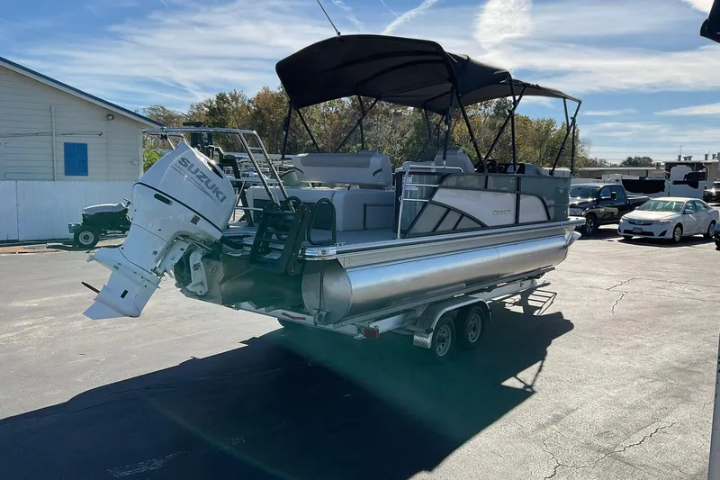 Slide: The Image of 2026 Crest Conquest 230 SLSC pontoon boat with Suzuki outboard motor on trailer. - 4