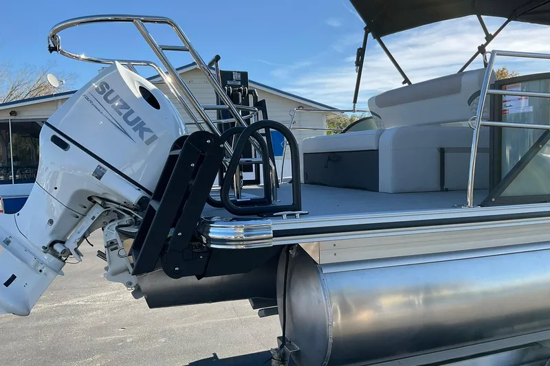 Slide: The Image of 2026 Crest Conquest 230 SLSC pontoon boat with Suzuki outboard motor, docked outdoors. - 5