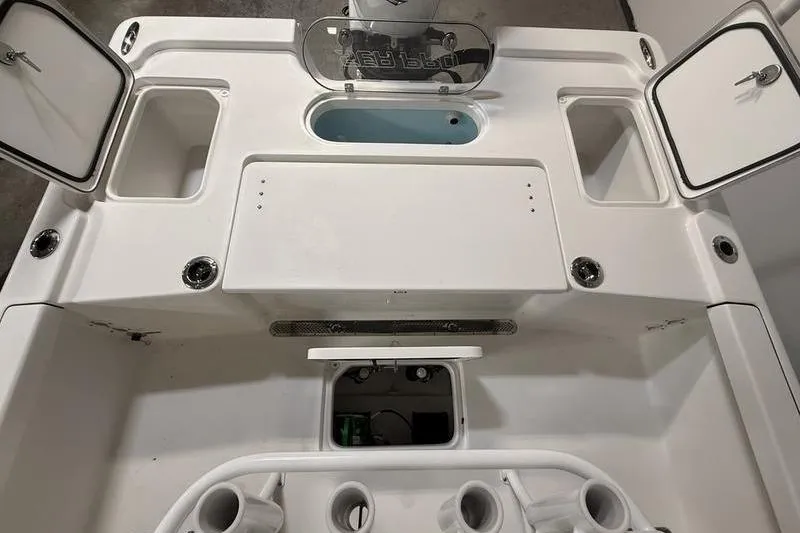 Slide: The Image of 2026 Sea Pro 250 Bay boat interior with storage compartments and livewell. - 11