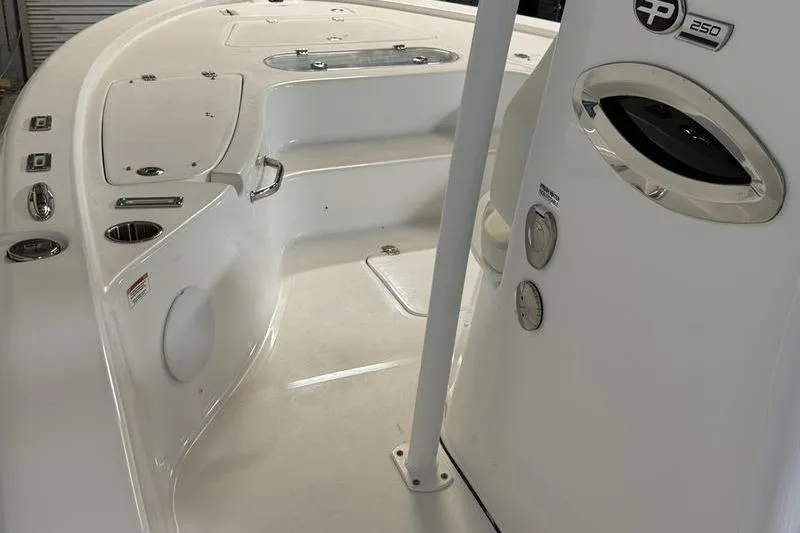 Slide: The Image of 2026 Sea Pro 250 Bay boat interior with sleek white design and modern controls. - 14