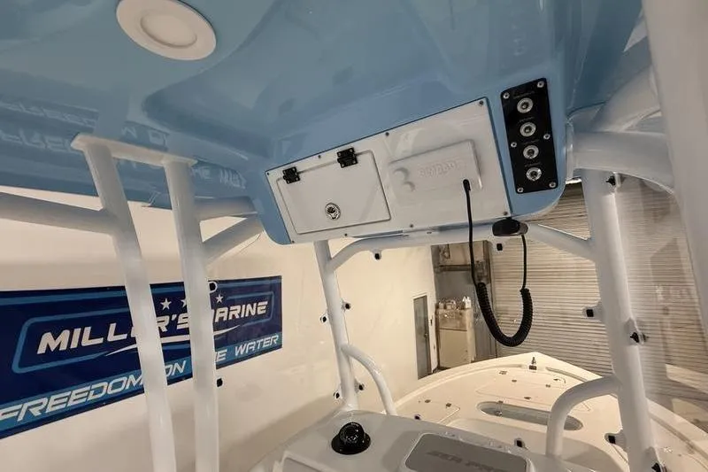 Slide: The Image of Interior view of a 2026 Sea Pro 250 Bay boat with control panel and storage. - 18