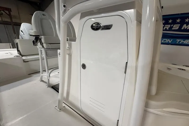 Slide: The Image of 2026 Sea Pro 250 Bay boat interior with seating and storage compartment. - 21