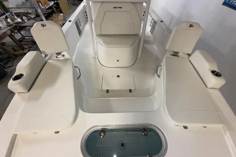 Slide: The Image of 2026 Sea Pro 250 Bay boat interior with seating and storage compartments. - 25