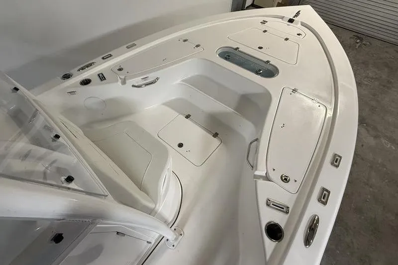Slide: The Image of 2026 Sea Pro 250 Bay boat interior with storage compartments and seating. - 27