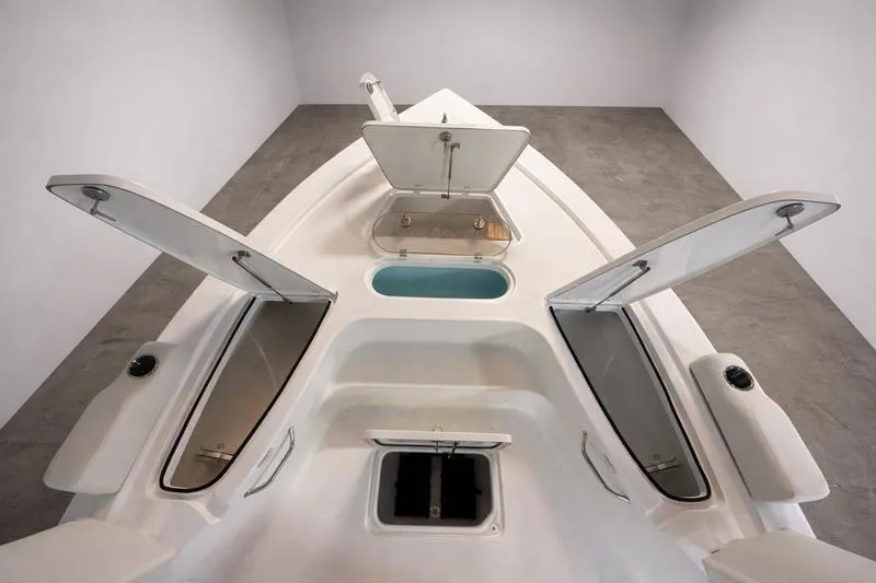Slide: The Image of 2026 Sea Pro 250 Bay boat interior with open storage compartments and sleek design. - 28