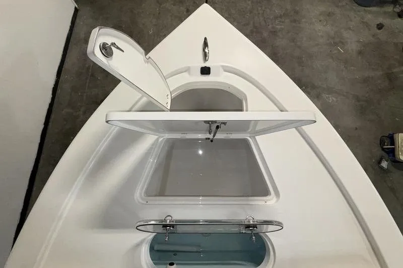 Slide: The Image of 2026 Sea Pro 250 Bay boat storage compartments, open view from above. - 29