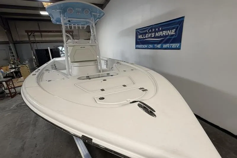 Slide: The Image of 2026 Sea Pro 250 Bay boat displayed indoors at Miller's Marine showroom. - 3
