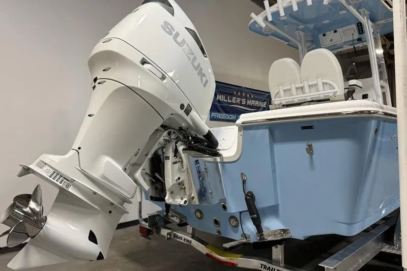 Slide: The Image of 2026 Sea Pro 250 Bay boat with Suzuki outboard motor in showroom. - 4