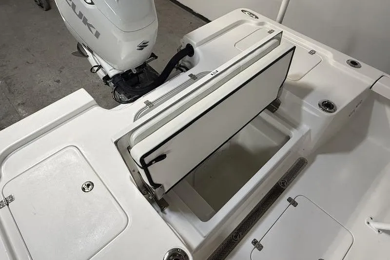Slide: The Image of 2026 Sea Pro 250 Bay boat with open storage compartment and Suzuki outboard motor. - 7