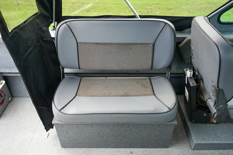 Slide: The Image of Interior seating of 2010 Alumaweld Stryker Sport 20 boat, featuring gray upholstery. - 11
