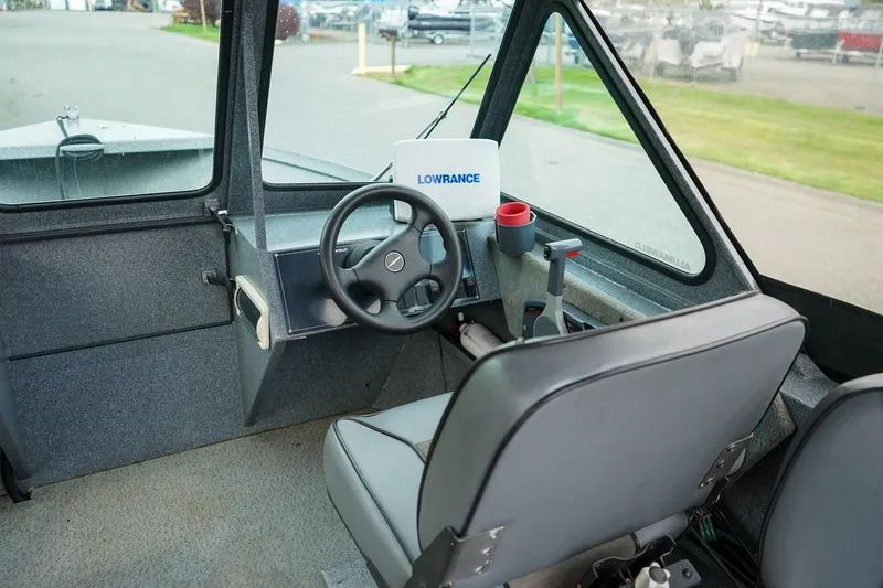 Slide: The Image of Interior of 2010 Alumaweld Stryker Sport 20 boat with steering wheel and controls. - 13