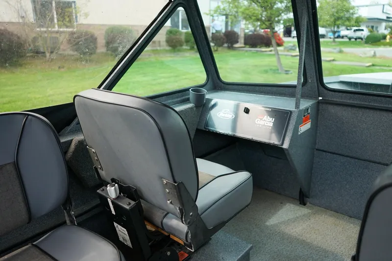 Slide: The Image of Interior of a 2010 Alumaweld Stryker Sport 20 boat, featuring seating and dashboard. - 16