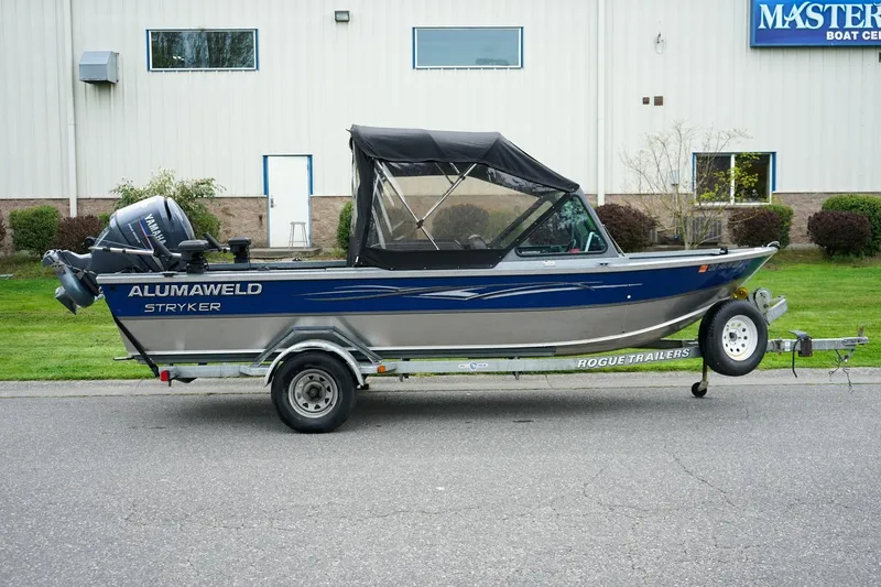 Slide: The Image of 2010 Alumaweld Stryker Sport 20 boat on trailer, parked outside a building. - 3