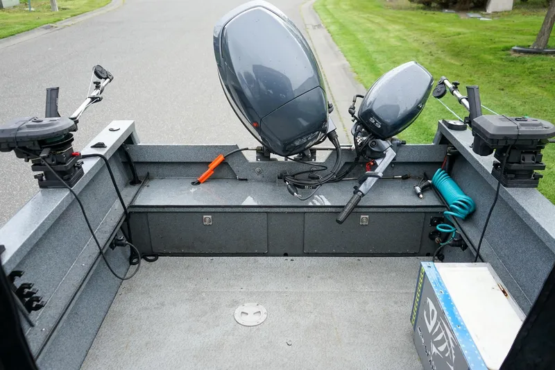Slide: The Image of 2010 Alumaweld Stryker Sport 20 boat interior with dual motors and fishing equipment. - 7