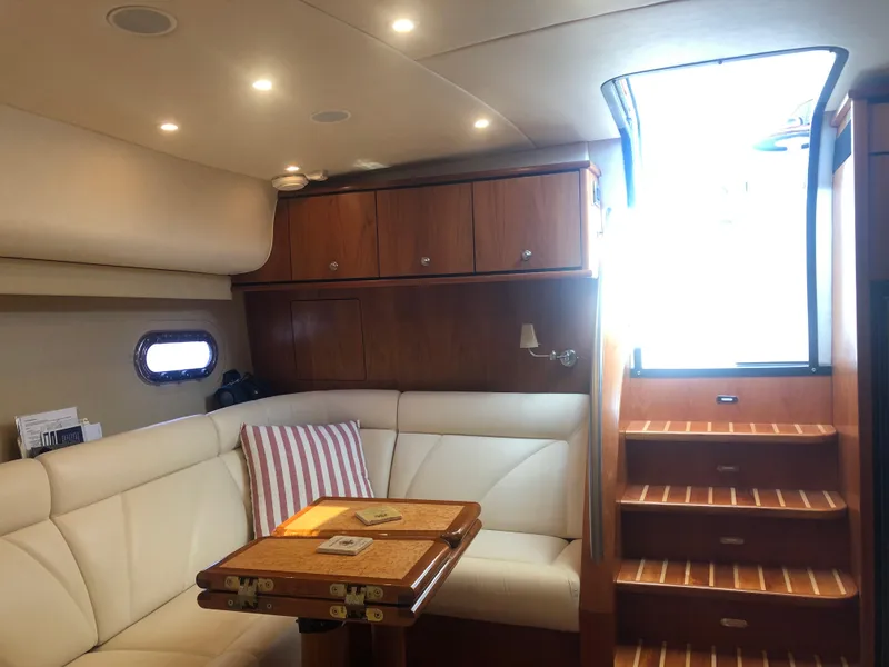 Slide: The Image of Interior of 2009 Tiara Yachts 4300 Sovran with leather sofa and wooden table. - 15