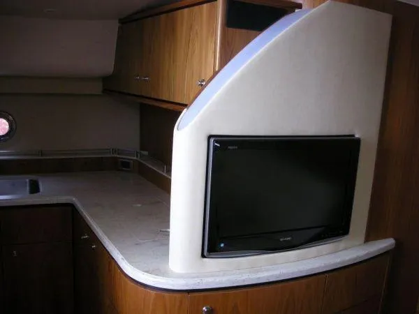 Slide: The Image of Interior of 2009 Tiara Yachts 4300 Sovran with TV and wooden cabinets. - 22