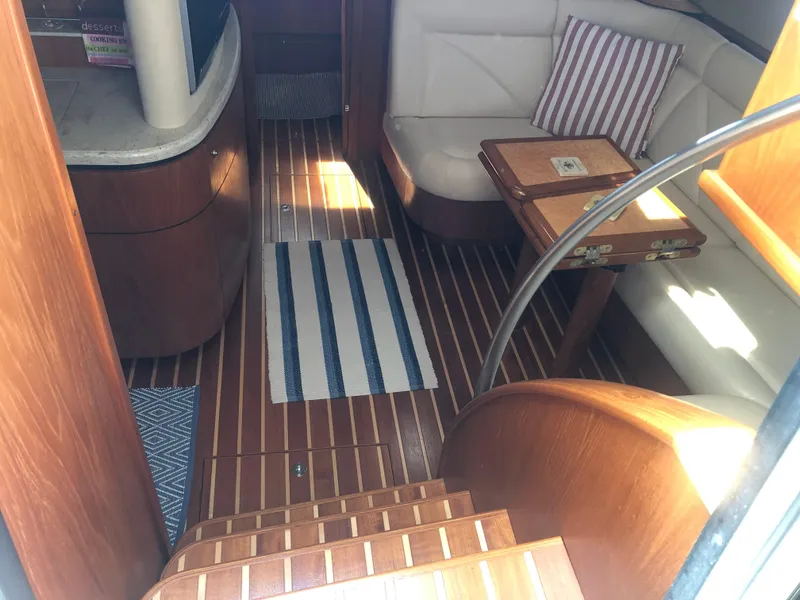 Slide: The Image of Interior of 2009 Tiara Yachts 4300 Sovran with wooden flooring and seating area. - 24