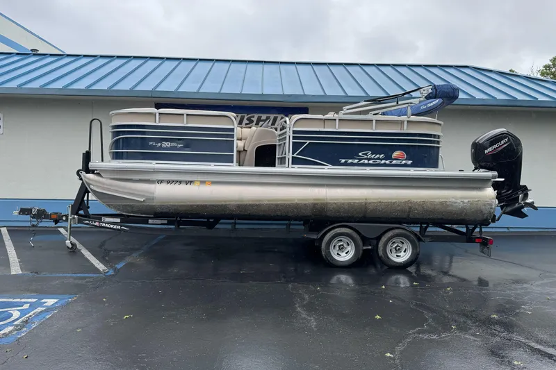 The Image of 2021 Sun Tracker Party Barge 20 DLX pontoon boat on trailer, parked outdoors. - 0