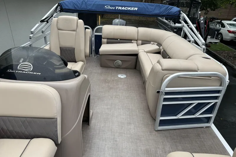 Slide: The Image of 2021 Sun Tracker Party Barge 20 DLX with beige seating and blue canopy. - 11