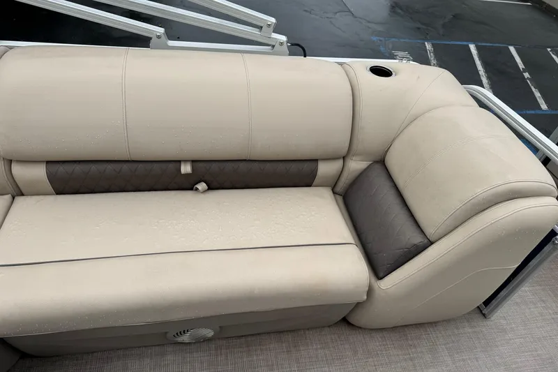 Slide: The Image of 2021 Sun Tracker Party Barge 20 DLX beige seating with cup holder and quilted accents. - 16