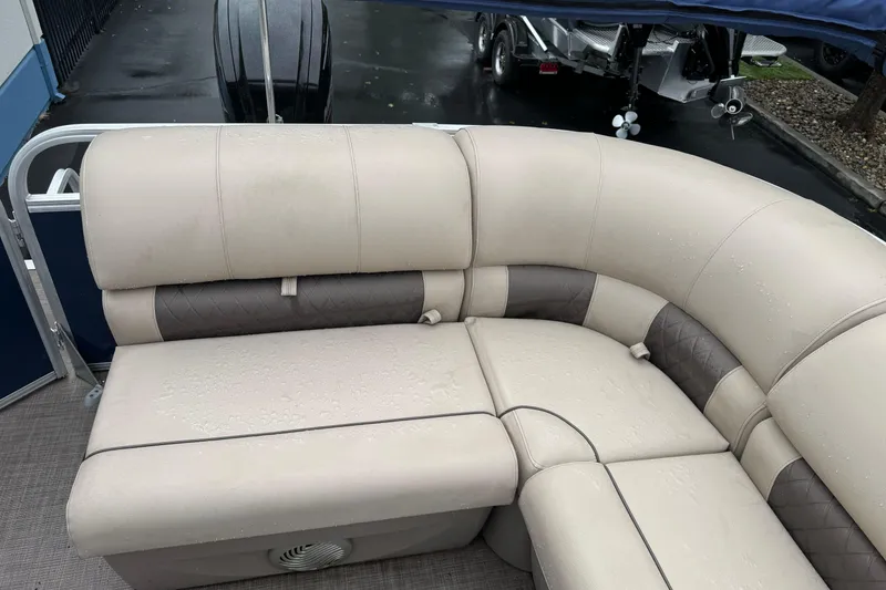 Slide: The Image of 2021 Sun Tracker Party Barge 20 DLX with beige and brown cushioned seating. - 17