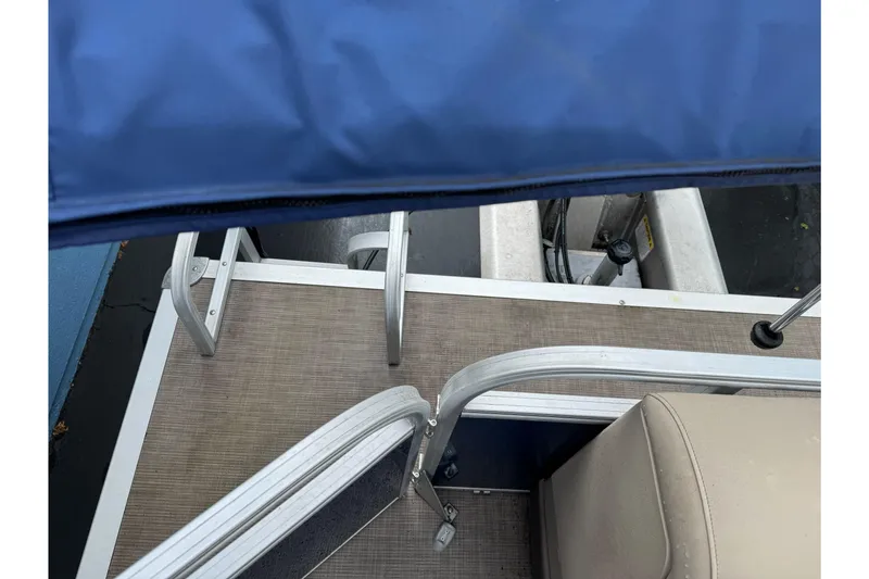 Slide: The Image of 2021 Sun Tracker Party Barge 20 DLX deck with blue canopy and seating. - 19