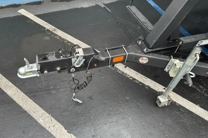 Slide: The Image of Trailer hitch of a 2021 Sun Tracker Party Barge 20 DLX on asphalt. - 3