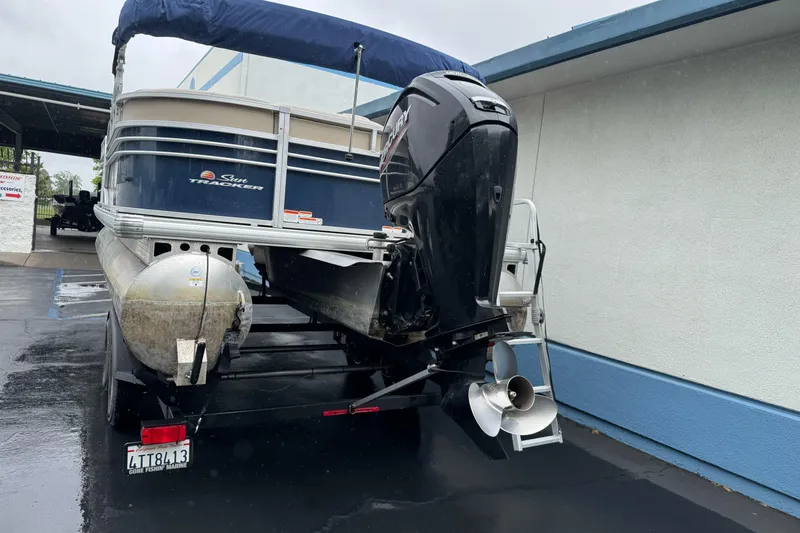 Slide: The Image of 2021 Sun Tracker Party Barge 20 DLX pontoon boat with outboard motor on trailer. - 5