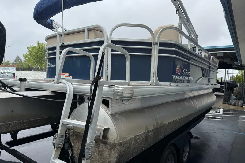 Slide: The Image of 2021 Sun Tracker Party Barge 20 DLX pontoon boat on trailer, side view. - 6