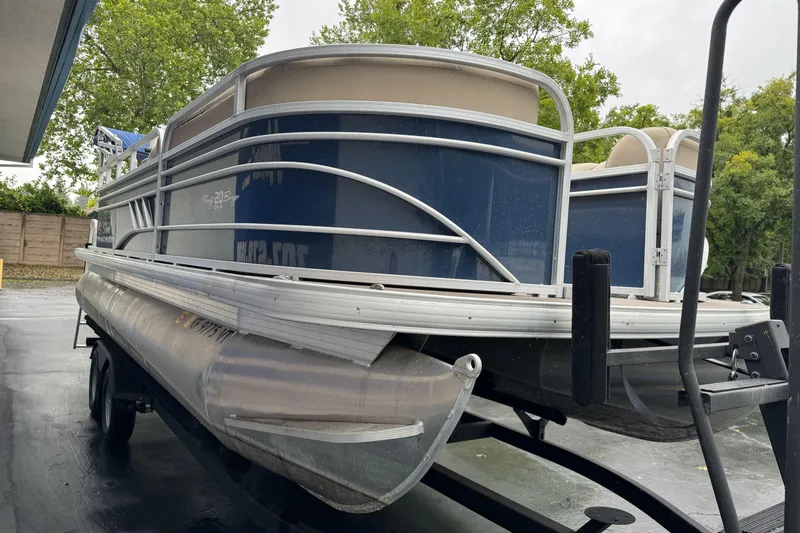 Slide: The Image of 2021 Sun Tracker Party Barge 20 DLX pontoon boat on trailer, parked outdoors. - 7