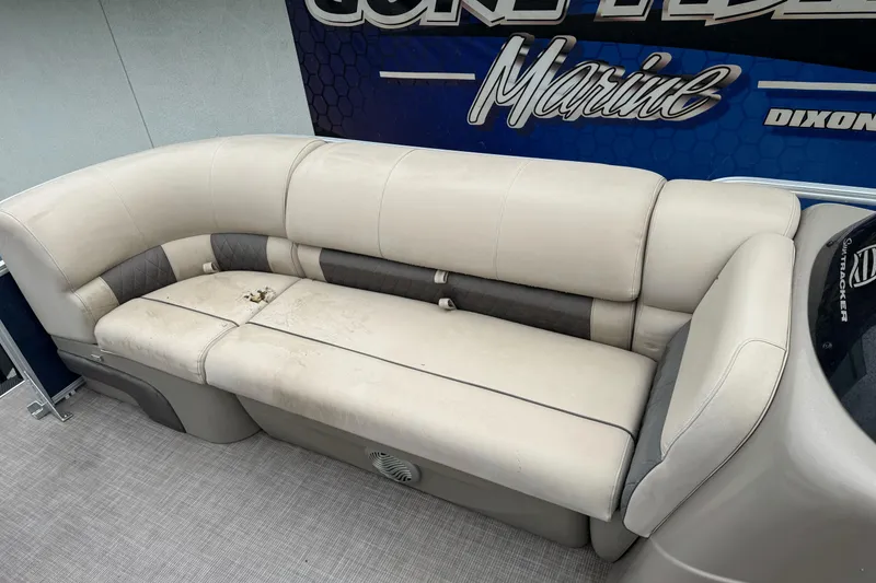 Slide: The Image of 2021 Sun Tracker Party Barge 20 DLX with beige seating and marine backdrop. - 8