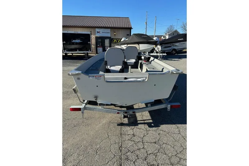 Slide: The Image of 2026 Smoker Craft Angler 16 SC boat on trailer, outdoor dealership setting. - 4