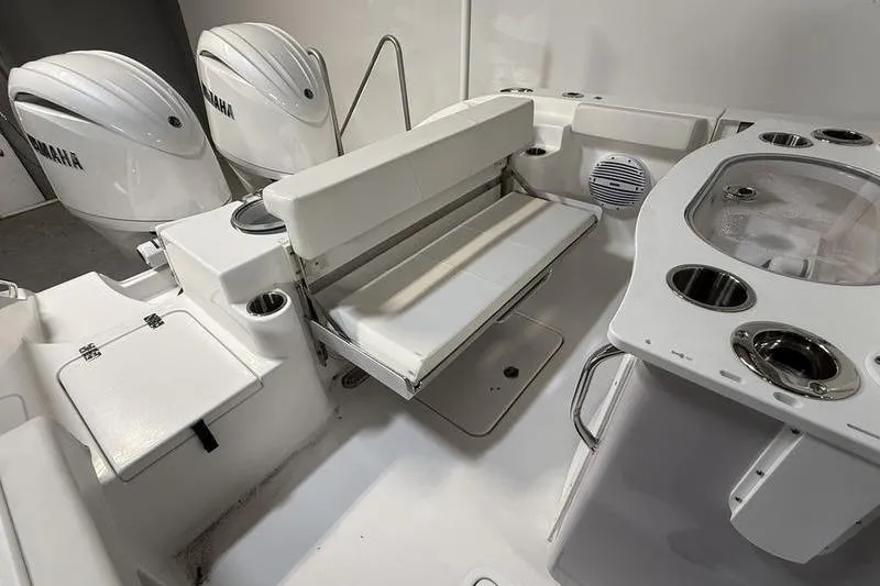 Slide: The Image of 2026 Sea Pro 262 DLX boat interior with Yamaha engines, featuring seating and storage. - 10