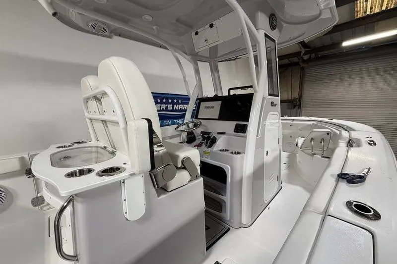 Slide: The Image of 2026 Sea Pro 262 DLX boat interior with helm, seating, and fishing amenities. - 15