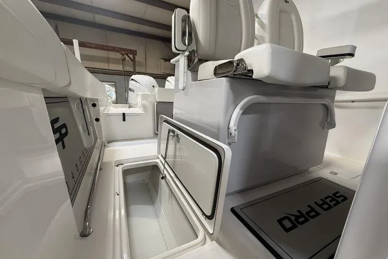 Slide: The Image of 2026 Sea Pro 262 DLX boat interior with storage compartments and seating. - 21