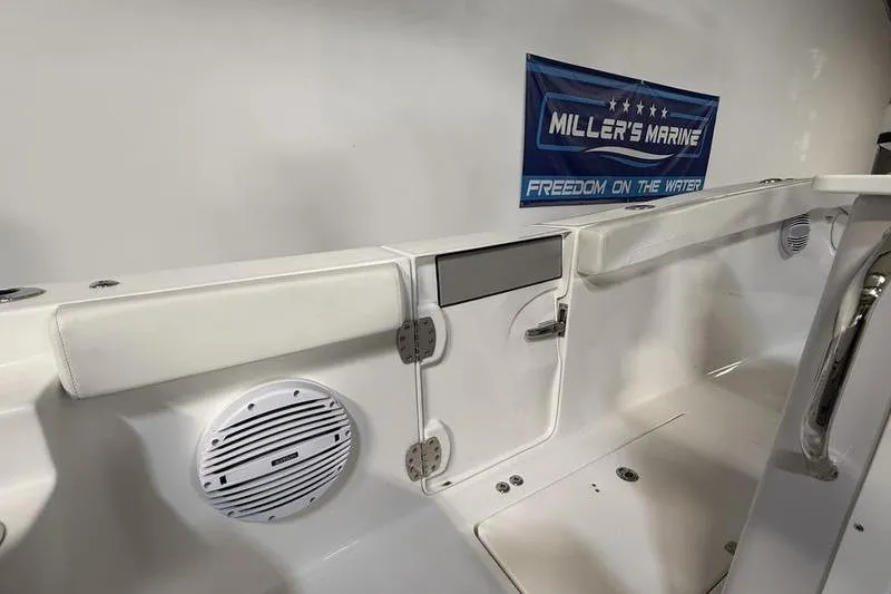 Slide: The Image of 2026 Sea Pro 262 DLX boat interior with speaker and Miller's Marine sign. - 23