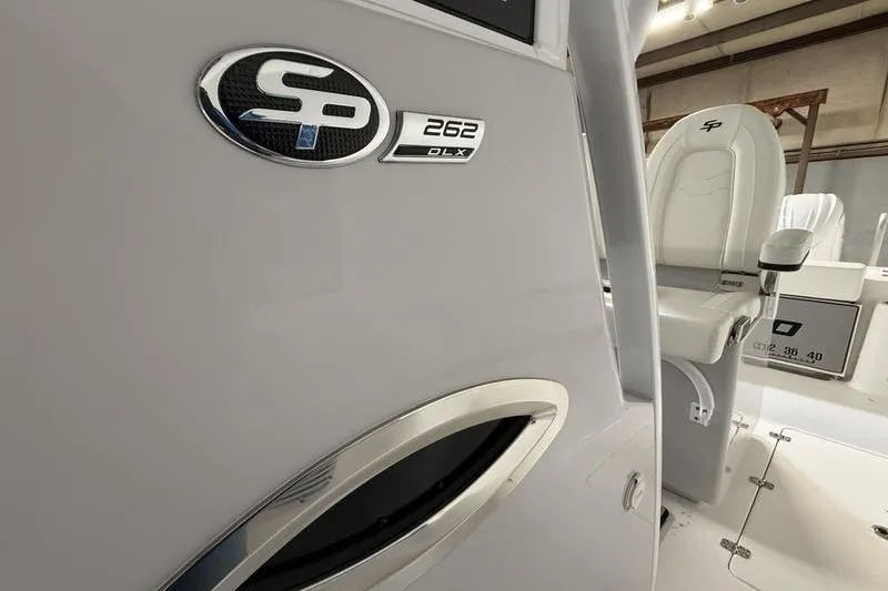 Slide: The Image of 2026 Sea Pro 262 DLX boat interior with logo and seating detail. - 24
