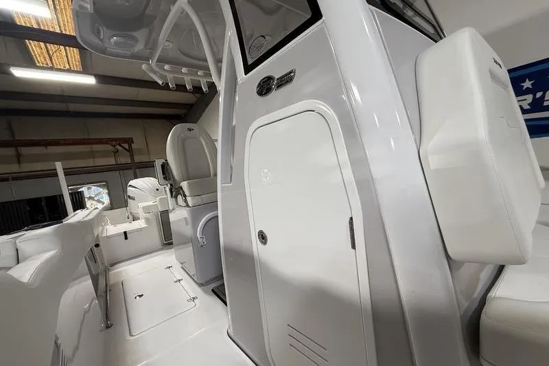 Slide: The Image of 2026 Sea Pro 262 DLX boat interior, featuring sleek white design and modern seating. - 25