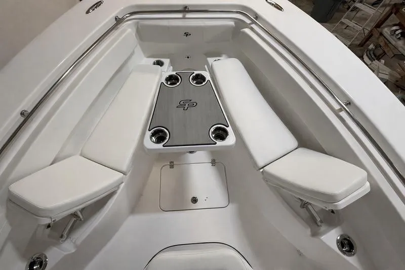 Slide: The Image of 2026 Sea Pro 262 DLX boat interior with cushioned seating and central table. - 30