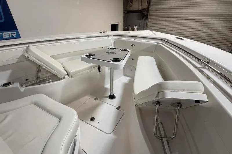 Slide: The Image of 2026 Sea Pro 262 DLX boat interior with seating and table, featuring cup holders. - 31