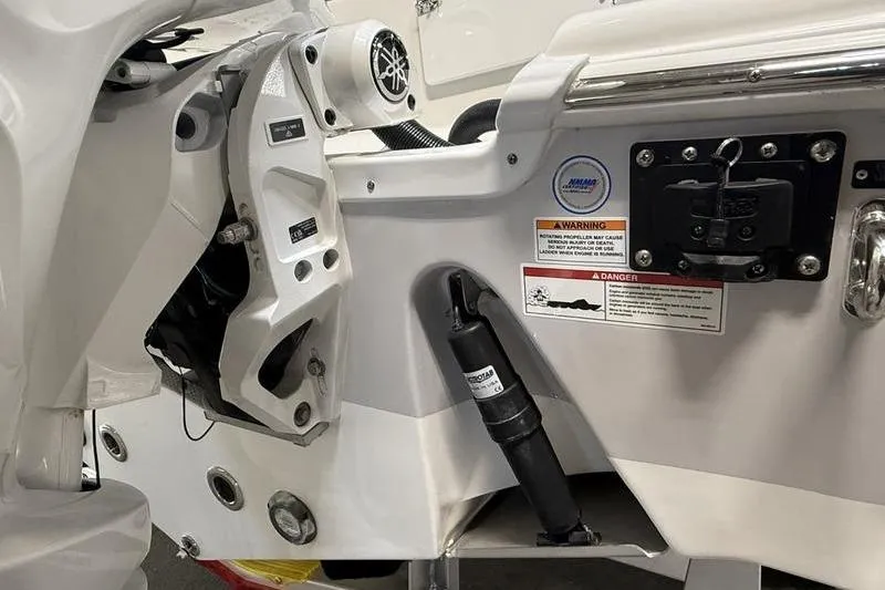 Slide: The Image of Close-up of 2026 Sea Pro 262 DLX boat's engine mount and warning labels. - 6