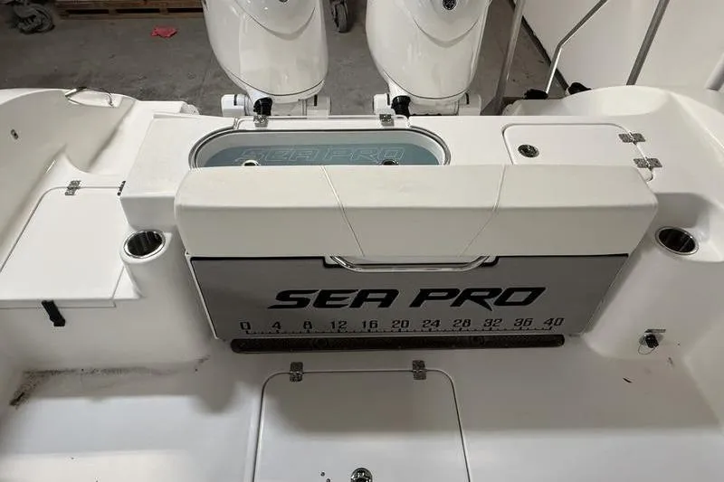 Slide: The Image of 2026 Sea Pro 262 DLX boat interior with storage and measurement markings. - 7
