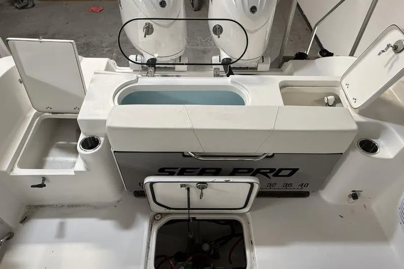 Slide: The Image of 2026 Sea Pro 262 DLX boat interior with storage compartments and livewell. - 8