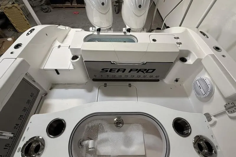 Slide: The Image of 2026 Sea Pro 262 DLX boat interior with fishing amenities and storage compartments. - 9