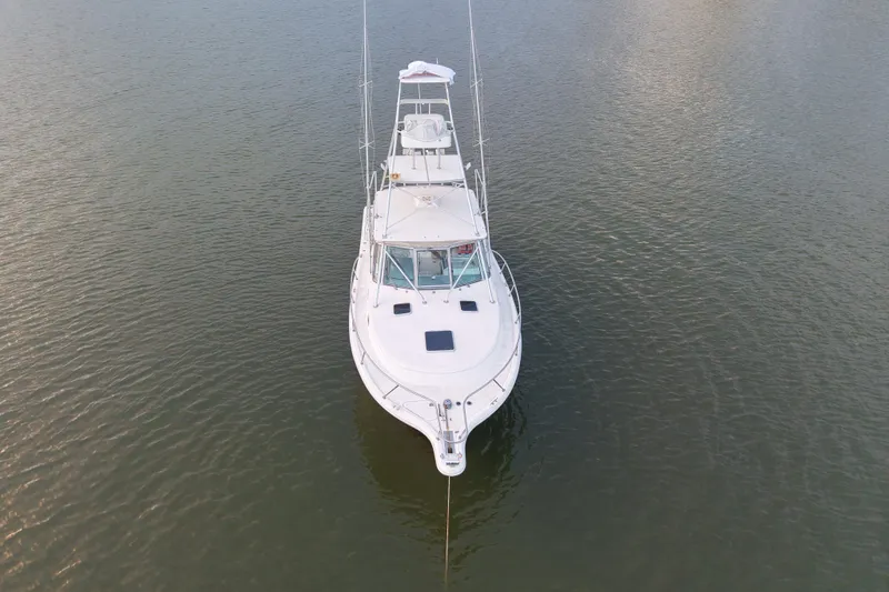 Slide: The Image of Aerial view of 2000 Pursuit 3400 Express boat on calm water. - 11