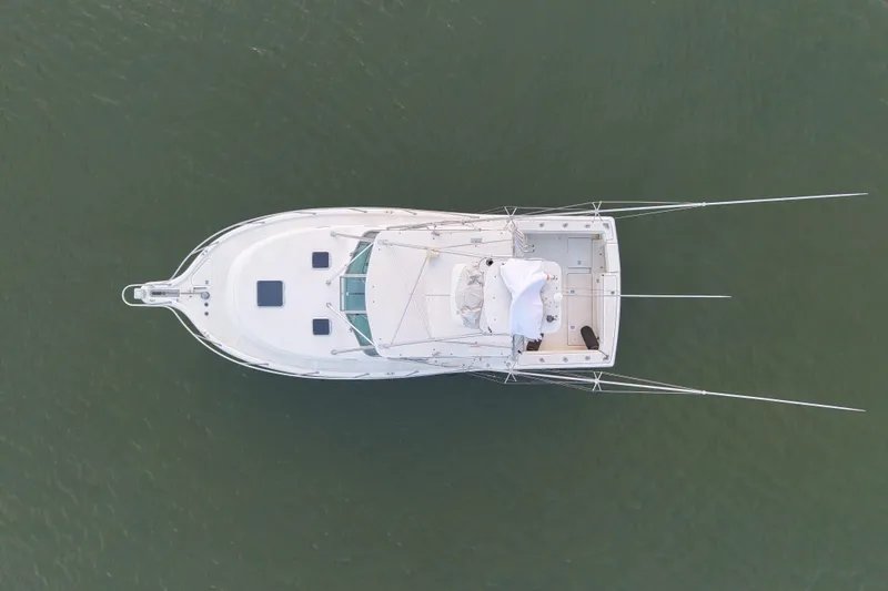 Slide: The Image of Aerial view of 2000 Pursuit 3400 Express boat on calm water. - 13