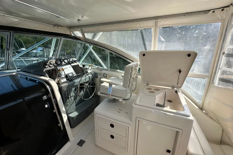 Slide: The Image of Helm of 2000 Pursuit 3400 Express boat with steering wheel and control panel. - 15