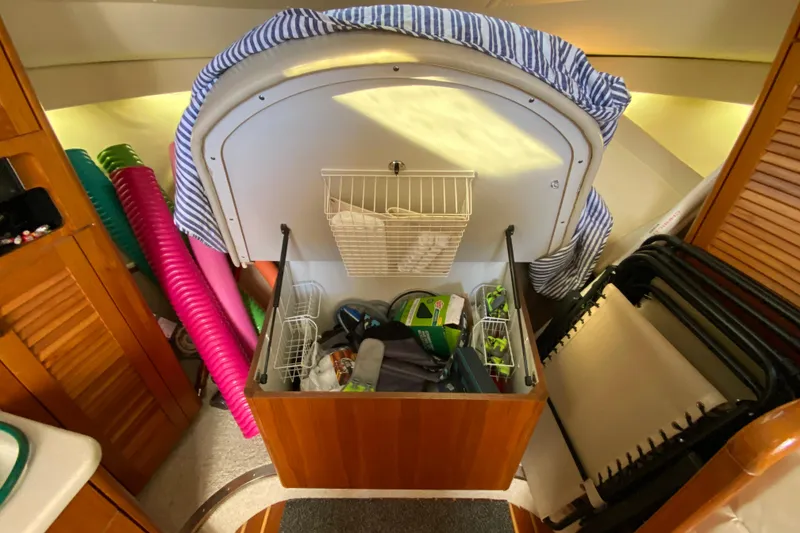 Slide: The Image of Storage area inside a 2000 Pursuit 3400 Express boat, featuring organized supplies and equipment. - 25